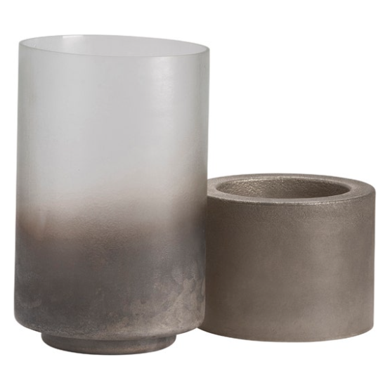 The Clara Metallic Smoke Hurricane is a cylindrical frosted glass vase with a gradient from smoky gray to clear, resembling a stylish candle holder. Paired with it is a short, round concrete base featuring a textured surface and hollow center for support. Both offer modern minimalist design ideal for transitional decor.