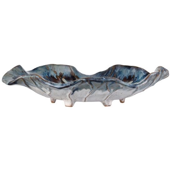 The Earthenware Charger features an organic shape reminiscent of a leaf with its wavy edges and showcases a stunning reactive drop glaze. The dark blue, teal, and earthy brown tones blend seamlessly, while several small feet support its slightly elevated design, complemented by smooth textures and subtle ridging.