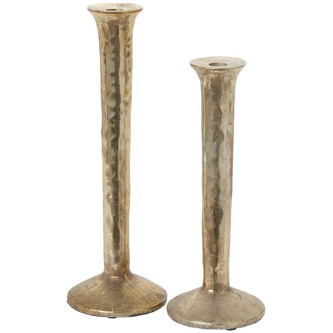 The Celestial Gold Candlestick set, consisting of two metallic candleholders, is showcased with a stunning mottled gold finish. Both pieces feature a hammered, textured design and flared base for stability. One stands taller than the other, presenting a simple yet elegant aesthetic ideal for various decorative settings.