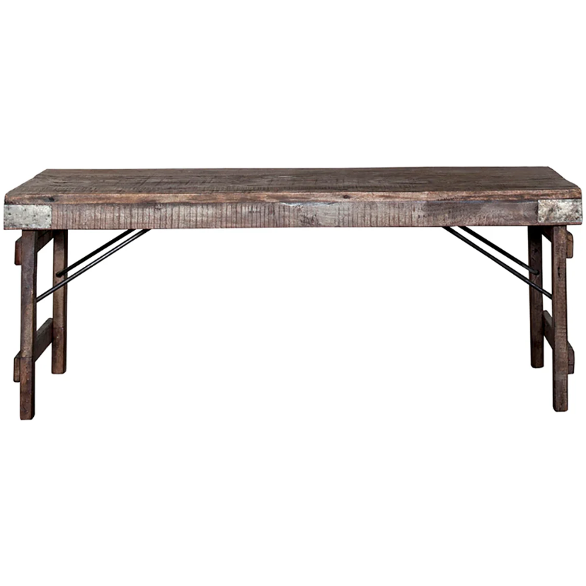 The Collapsible Wedding Bench is a rustic, hand-crafted wooden piece with a rectangular top and sturdy legs. It features a weathered finish for a vintage look ideal for luxurious Indian weddings. Metal braces enhance its industrial style, while the surface showcases natural grain patterns and distress marks.