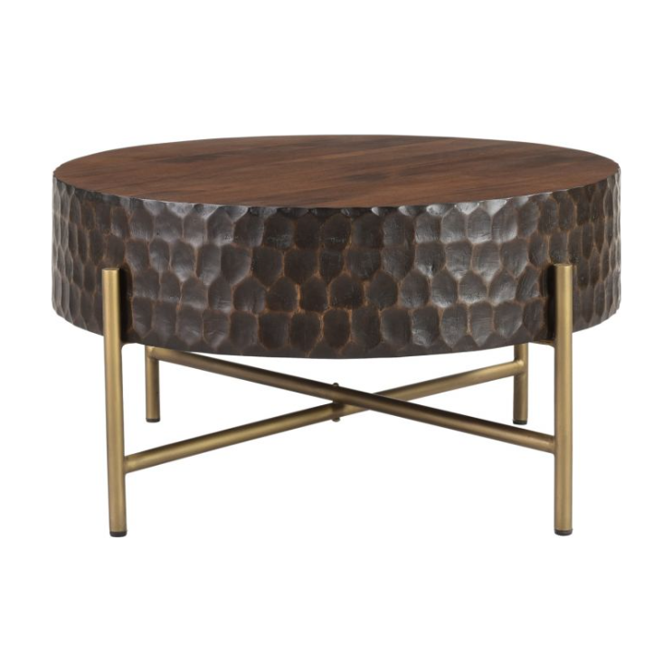 A round Cruz Coffee Table with a dark mango wood top and a textured metal base. The base features a unique hammered finish and is supported by intersecting bronze legs.