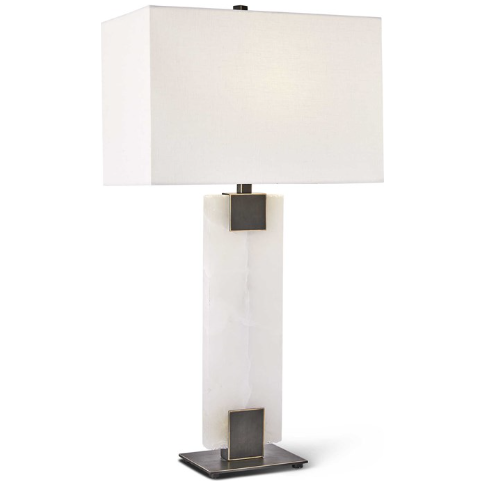 The Calista Table Lamp features a contemporary design with a rectangular alabaster white marble base. It is complemented by a sleek, rectangular white fabric lampshade with clean lines. The base boasts metallic accents at both the top and bottom and rests elegantly on a flat, square metal platform.