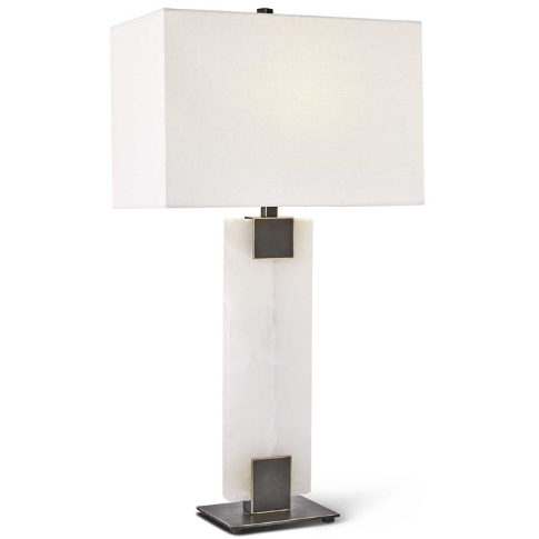 The Calista Table Lamp features a contemporary design with a rectangular alabaster white marble base. It is complemented by a sleek, rectangular white fabric lampshade with clean lines. The base boasts metallic accents at both the top and bottom and rests elegantly on a flat, square metal platform.