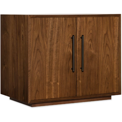 The Soren Walnut Two-Door Cabinet features a rich brown finish, walnut veneers, and vertical black metal handles. Its simple modern design and clean lines complement any modular desk system.
