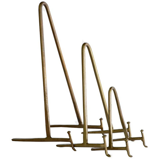 Three Antique Brass Display Easels of varying heights are displayed in a row against a plain white background. Each easel features a simple, minimalist design with an angled back support and a flat base equipped with two small brackets to hold an item in place. The tallest easel is positioned at the back, while the smallest is in front.