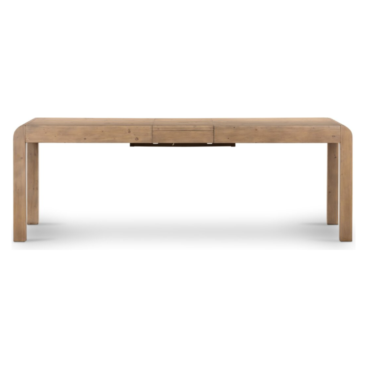 The Lotta Extension Dining Table, with its rectangular Parsons-style design and light brown finish, features smooth, rounded edges and sturdy square legs. Its minimalist aesthetic boasts clean lines, making it perfect for dining or use as a workspace. The seamless white floor and background accentuate the table beautifully.