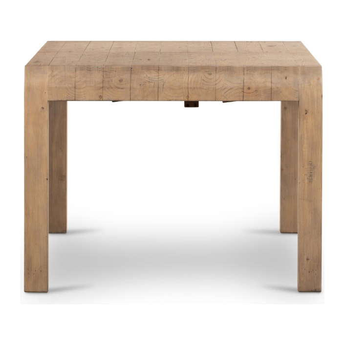 The Lotta Extension Dining Table, made from reclaimed wood, showcases a natural, rustic finish. Its Parsons-style design with four straight legs highlights visible wood grain patterns. The smooth yet slightly worn surfaces add to its charm, standing elegantly against a white backdrop.