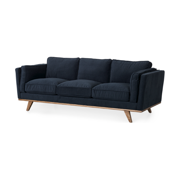 Introducing the Zinnia Sofa, a mid-century modern three-seater upholstered in premium navy blue fabric. It features plush cushions and slightly flared armrests, complemented by a sleek wooden base with solid wood legs angled outward. This elegant piece combines contemporary style with vintage charm for a truly timeless appeal.