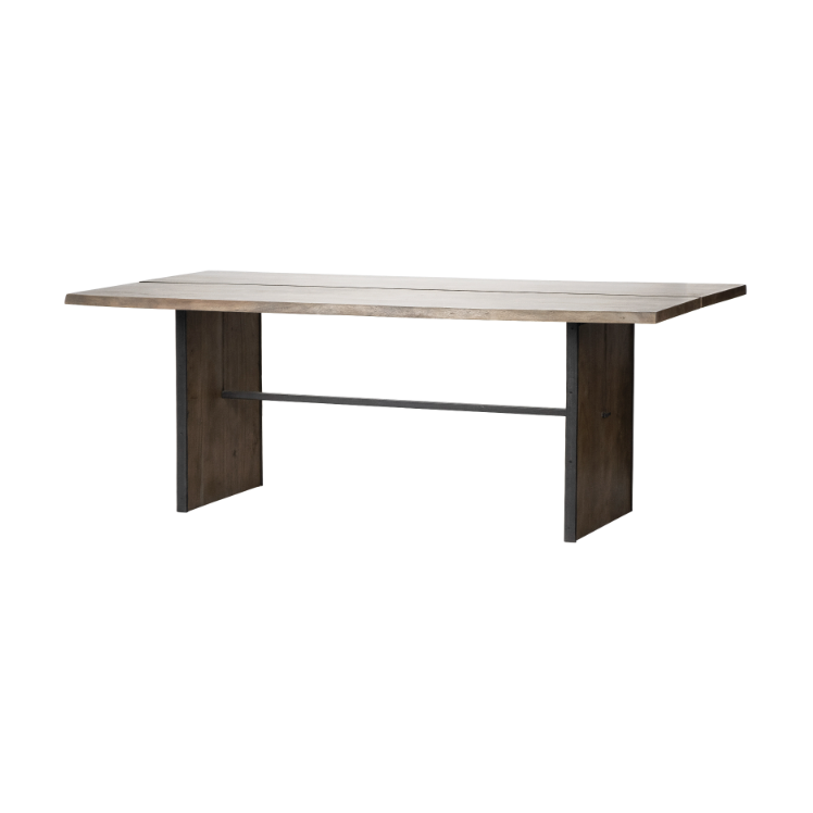 The Vesper 84" Dining Table features a contemporary rectangular design, showcasing a light Indian mango wood surface paired with dark solid wood plank-style legs. These legs are connected by a horizontally running black metal support bar, enhancing stability. The table boasts clean, straight lines and embodies a minimalist aesthetic.