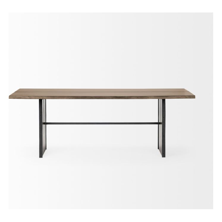 The Vesper 84" Dining Table is a minimalist wooden table featuring a rectangular top crafted from Indian mango wood and sleek black metal legs. The design includes a crossbar connecting solid wood plank-style legs for added stability and support. Set against a white background, the table showcases its modern and simple aesthetic.