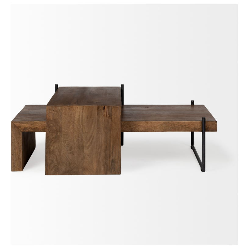 The Thomas Nesting Coffee Tables feature a contemporary design with an asymmetrical aesthetic crafted from solid Mango wood. The larger table includes a substantial rectangular wood block on the left side and an extended flat top surface on the right, all supported by sleek U-shaped iron legs, embodying both robustness and minimalism.