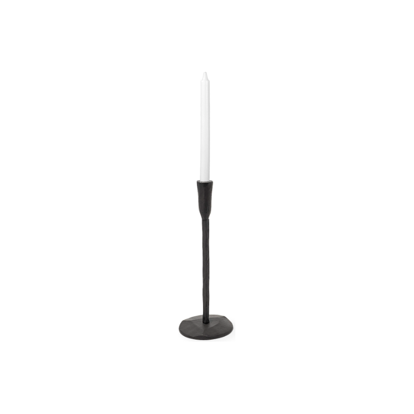 The Levi Iron Candlestick, with its minimalist black finish and round base, stylishly holds a tall, slim white candle. The sleek, modern design of the holder exudes rustic elegance, while the unlit candle stands out against the plain white background, emphasizing simplicity.