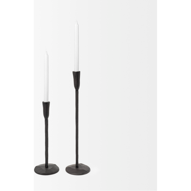 Introducing the Levi Iron Candlestick: two slim, elegant candle holders of differing heights in a chic black finish. Nestled atop these stylish holders are thin, white taper candles. The minimalist design features a simple, straight stem and a round base, highlighting graceful lines against a plain white background—a true embodiment of rustic elegance.