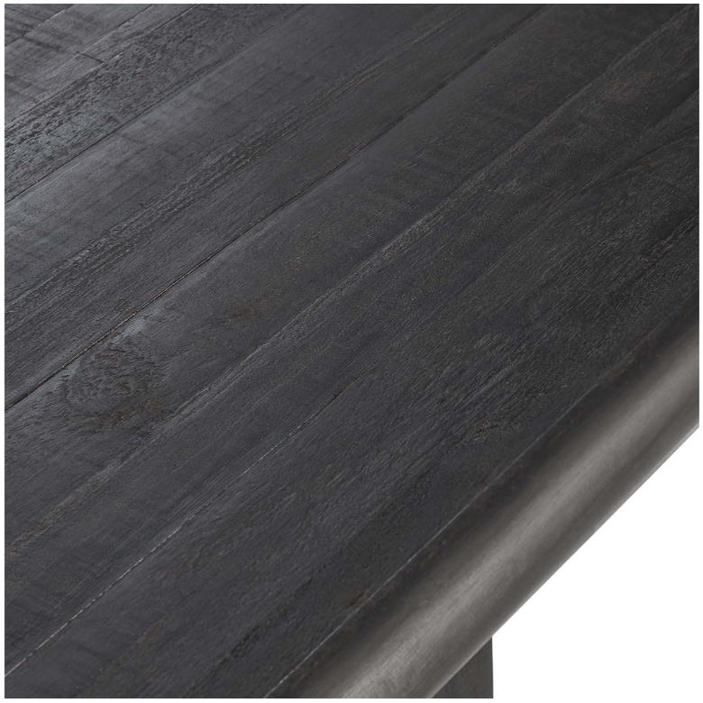 Close-up view of the Echo Reclaimed 96" Dining Table featuring a dark wooden tabletop with a smooth, textured surface showcasing visible wood grain and subtle natural imperfections. The edge of this elegant reclaimed pine dining table is rounded, displaying a polished, seamless finish. The corner of the table is slightly visible in the bottom right of the image.