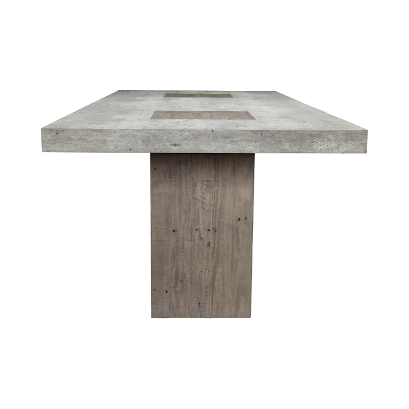 The Arizona Concrete 94" Dining Table features a rectangular concrete top with two cut-out sections near the center, supported by a single, wide wooden pedestal leg. The smooth, grey concrete surface contrasts beautifully with the natural, rustic texture of the reclaimed pine base, showcasing visible grain and knots.