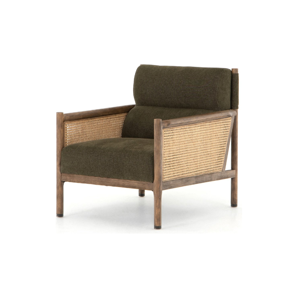 The Julius Accent Chair combines dark olive green cushions with a wooden frame, featuring woven cane accents on the sides and back for a French-inspired touch. It offers a sturdy, minimalist look against a plain white background.