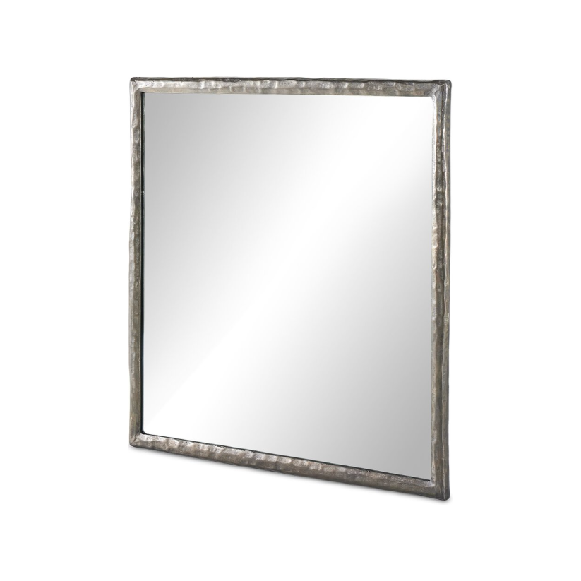 The Hammered Nickel Wall Mirror features a square, slightly irregular frame with a textured, silver beveled design. The rustic, handcrafted appearance of the frame has uneven edges that add character and charm. Its mirror surface reflects light beautifully, highlighting its clear and reflective quality. This mirror is ideal for enhancing home decor against a plain white background.