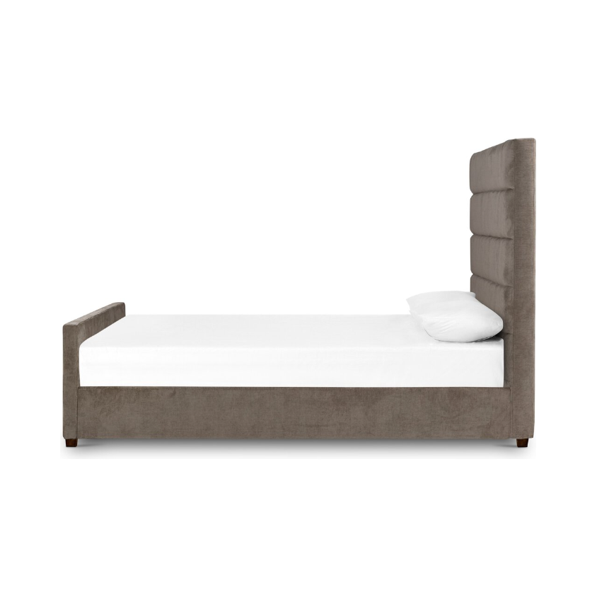 The side view showcases the sophisticated Seraphine Bed, featuring a tall and tufted headboard alongside a low footboard. It is upholstered in lavish gray fabric. Complemented by a white mattress with two matching white pillows, the setup is elegantly placed against a plain white background, highlighting its minimalist and contemporary design.