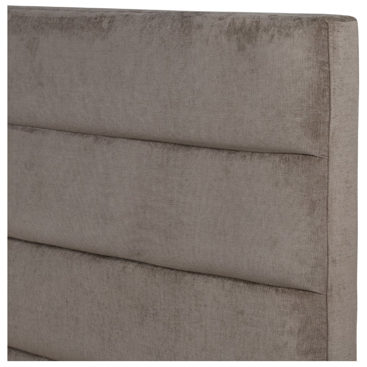 The Seraphine Bed's headboard features a detailed, close-up view of textured light brown fabric with horizontal cushioned panels. The upholstery exudes a luxurious, gently worn appearance for a soft and inviting look, further highlighted by vertical and horizontal seams that enhance its padded, structured design.