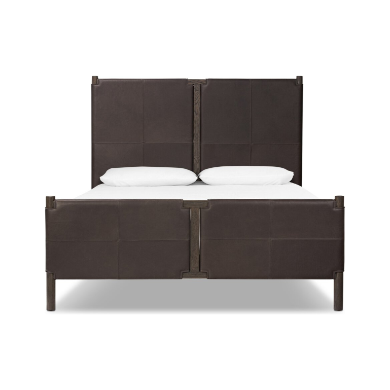 Front view of the Valencia Haven Bed, highlighting its dark brown, safari-inspired elegance. The tall headboard and footboard are made from upcycled leather with a segmented design. Clean, straight lines are accentuated by two white pillows and four square legs, with a shadow underneath indicating a gentle light source.