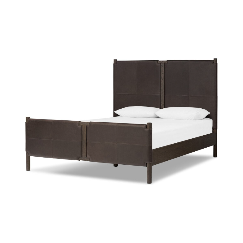 The Valencia Haven Bed features a sophisticated safari-inspired design, highlighted by its dark brown frame upholstered in upcycled leather and a tall headboard. The coordinating footboard pairs seamlessly with crisp white sheets and pillows to achieve a minimalist and modern aesthetic.