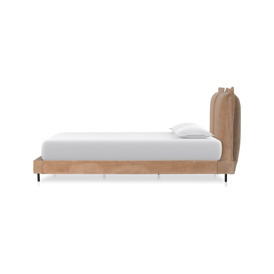 Side view of the Ashford Estate Bed, showcasing its beige upholstered headboard and frame. The comfortable headboard pairs beautifully with a white mattress and pillow. Supported by sleek black legs, its plush, cushioned design brings elegance and comfort to any contemporary bedroom.
