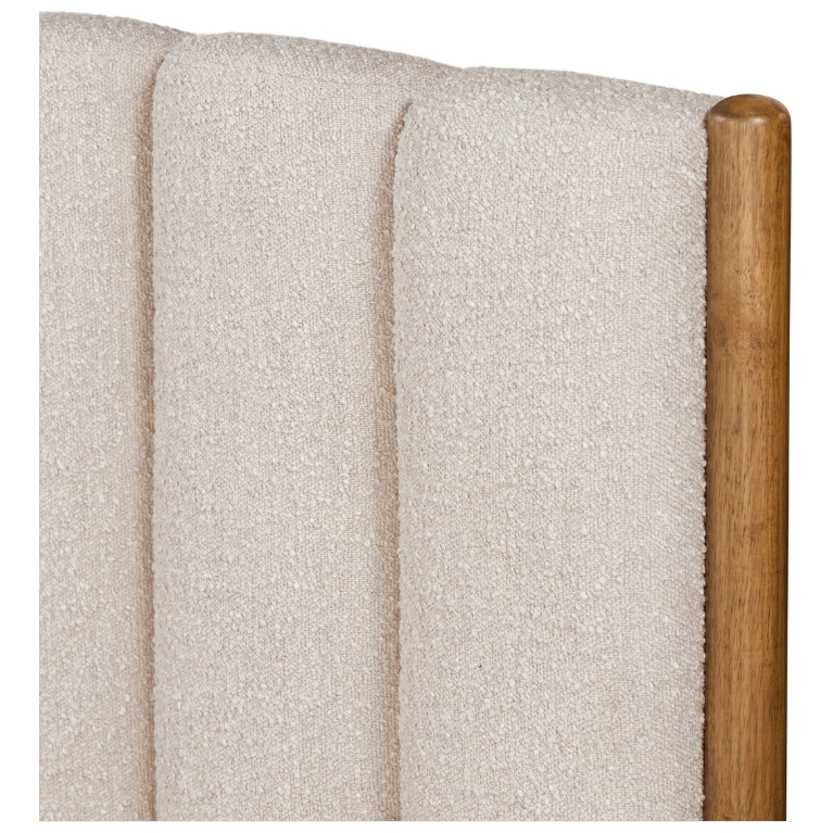 Here's a revised version of the sentence incorporating the product data:

A detailed view of the beige upholstered panel on the Savannah Bed showcases vertical stitching crafted from textured fabric. The right side features a rounded wooden edge, enhancing its modern and sophisticated design. The light brown finish beautifully complements the soft, neutral fabric, making it an ideal addition to any contemporary bedroom furniture collection.