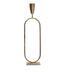 The Trumpet Candle Holder - Short is a tall, oval-shaped brass candlestick with a minimalist design and exquisite handcrafted detail. It features an elongated frame with a candle holder atop and a flat rectangular base for support, all in polished, shiny brass.