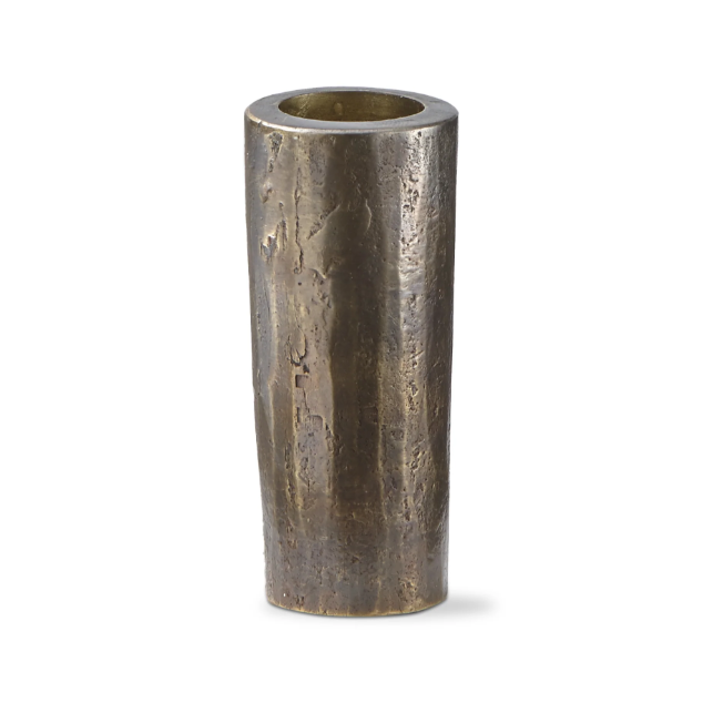 The Hammered Tall Taper Holder is a tall, cylindrical vase made of dark, textured metal with a rustic, uneven surface that highlights its hand-forged iron construction. It features a slightly tapered shape and wide opening and stands on a plain white background, casting a subtle shadow.