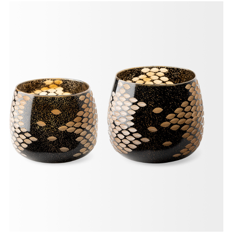 The Marina Black and Gold Glass Vases feature two pieces with elegant black bases adorned with a striking gold snake-skin pattern. The interiors sport a speckled gold design, enhancing their reflective, warm glow. One vase is slightly smaller and wider, while the other stands taller and narrower. Both vases boast a glossy finish highlighted by exquisite gold details.