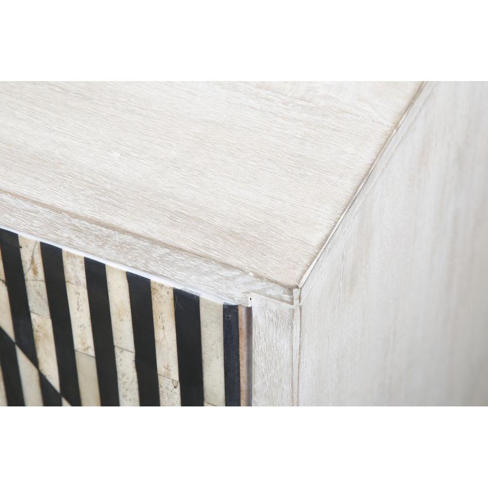 Close-up of the Terra Noir Sideboard Media Cabinet, showcasing a decorative front panel crafted from horn and mango wood with a geometric pattern of alternating black and white stripes for a striking contrast against the pale wood.