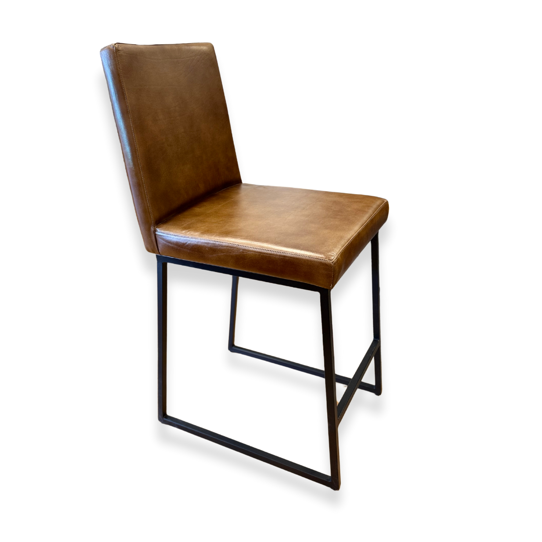 Theodore Leather Counter Stool: A modern chair with a brown leather seat and backrest, clean lines, and a minimalist black iron base with sled-style legs and open frame, shown against a plain white background.
