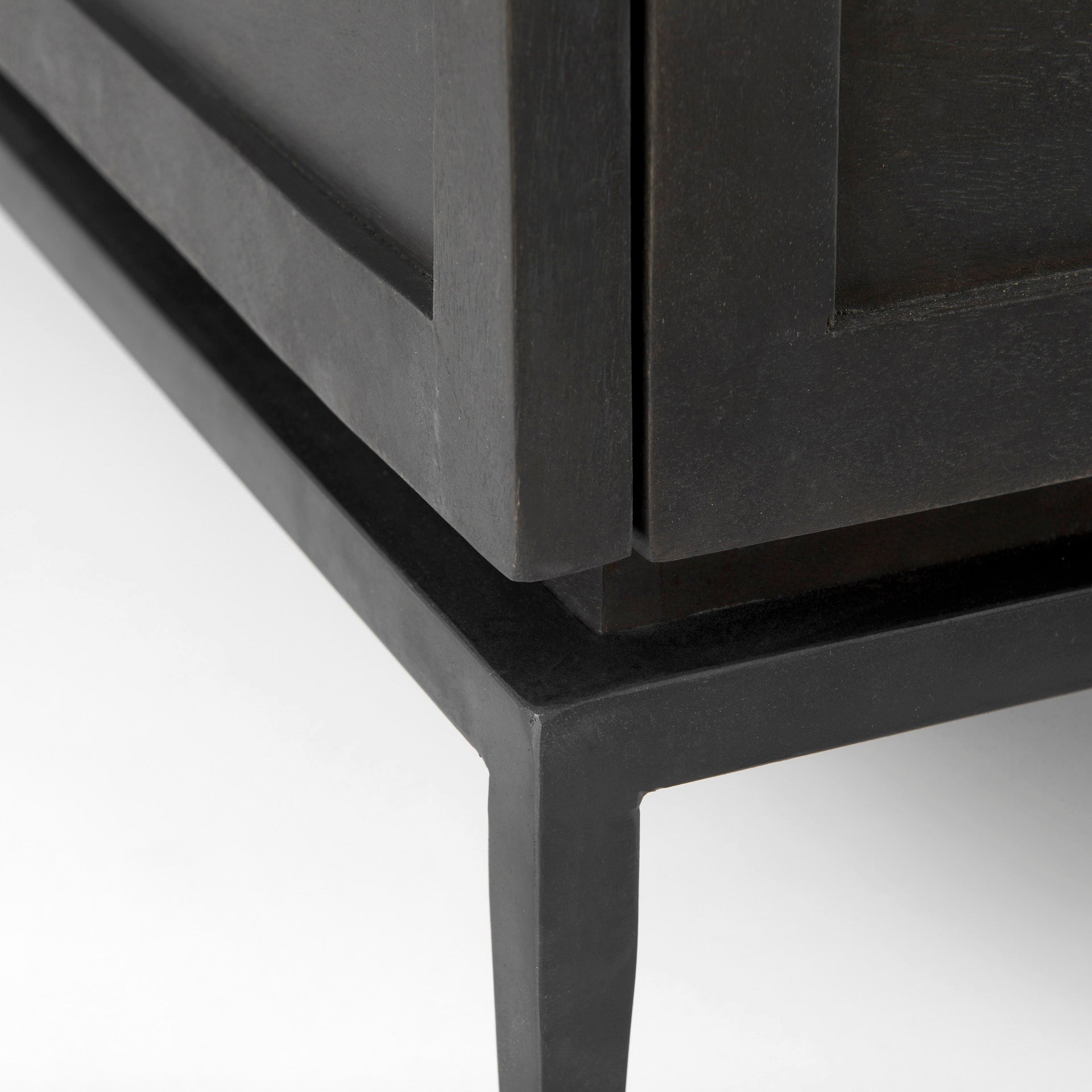 Close-up of a black metal frame corner on a white background