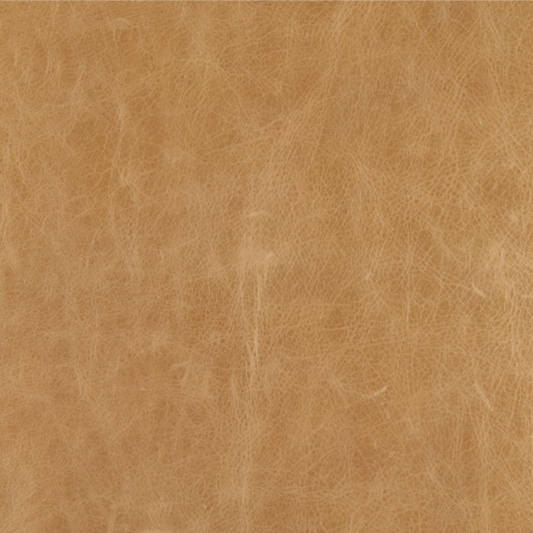 The buffalo leather texture of the Vercelli Handcrafted Leather Accent Chair shows intricate grain patterns and natural markings. Its surface is slightly worn with subtle shade variations, adding depth to its organic and modern minimalist design.