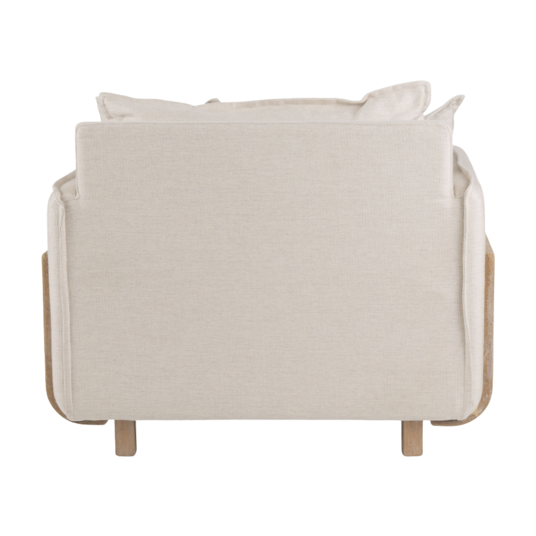 The Veyra Plush Upholstered Armchair in beige features a solid oak frame and legs, showcasing its plush comfort with soft square back and seat cushions, while its rounded wooden arms enhance its minimalist design from the back view.