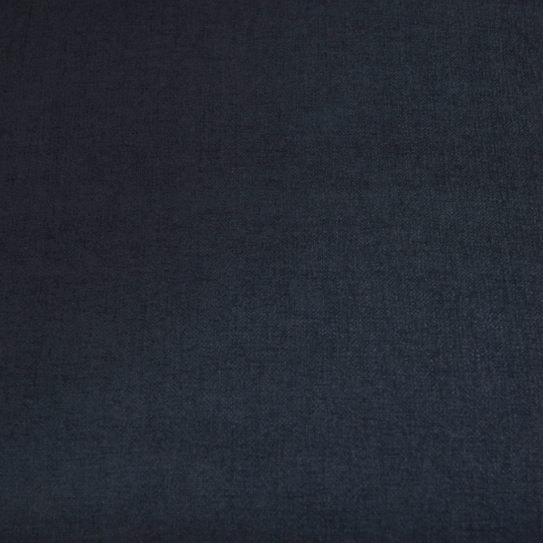 A close-up of navy fabric upholstery with a fine woven texture showcases the soft, smooth material and gentle shading—perfect for the Zinnia Mid-Century Modern Navy Fabric Sofa.