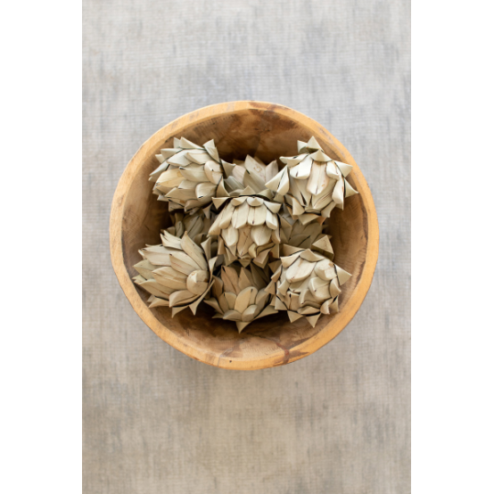 The Dolly Bag of Faux Artichokes features lifelike, pointed, and layered artichokes in a stylish bag—ideal for rustic decor or as a distinctive kitchen accent on any neutral, textured surface.