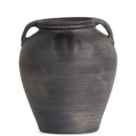 The Black Faith Terracotta Vase features a large, dark gray ceramic body with an aged black finish and a slightly tapered base. Its smooth surface is adorned with subtle horizontal lines and gentle color variations. Two small, curved handles near the top add to its rustic charm, making it an elegant decorative piece.