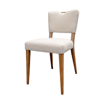 The Arden Gold Handle Dining Chair features a light beige upholstered seat and back with a top notch, set on four straight solid ash wood legs in a light brown finish, pictured against a plain white background.