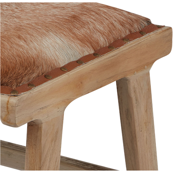 The Hair on Hide Accent Chair with Ottoman is a stunning statement piece featuring a seat covered in brown and tan fur. Decorative brass studs accentuate its organic modern design, while the wood's light, natural finish showcases the grain, particularly where the leg seamlessly merges with the seat.
