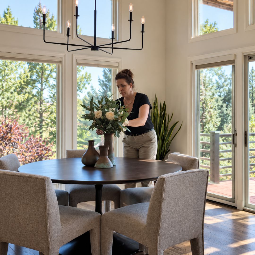 Interior designer Jaime Cawthron styles a dining table centerpiece during an in-home interior styling session.