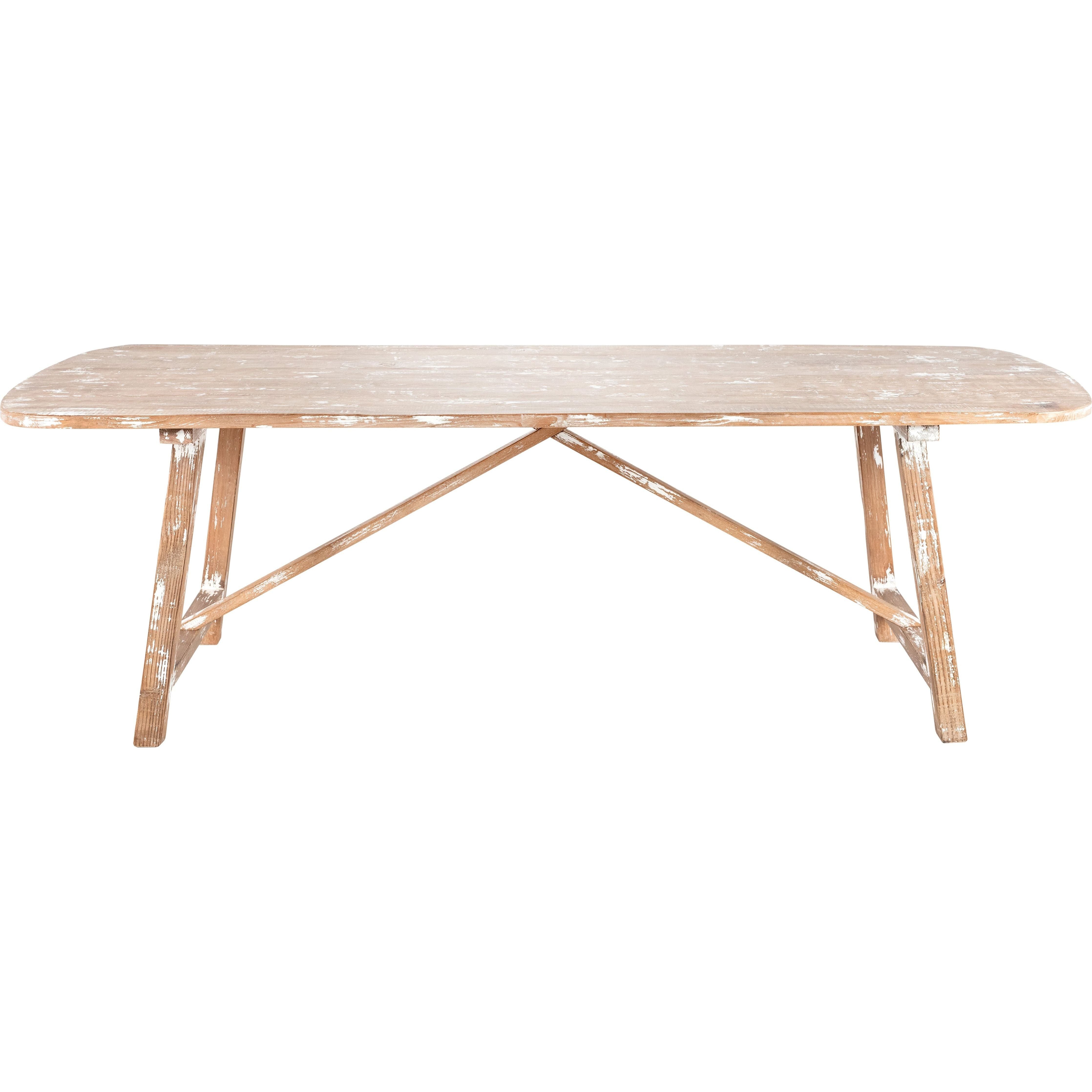 The Lexington Dining Table is a rectangular wooden piece with rustic sophistication and a distressed finish. Made from reclaimed pine, it features folding X-shaped legs with crossbars. Its simple, functional design highlights visible wood grain and a neutral light brown color.