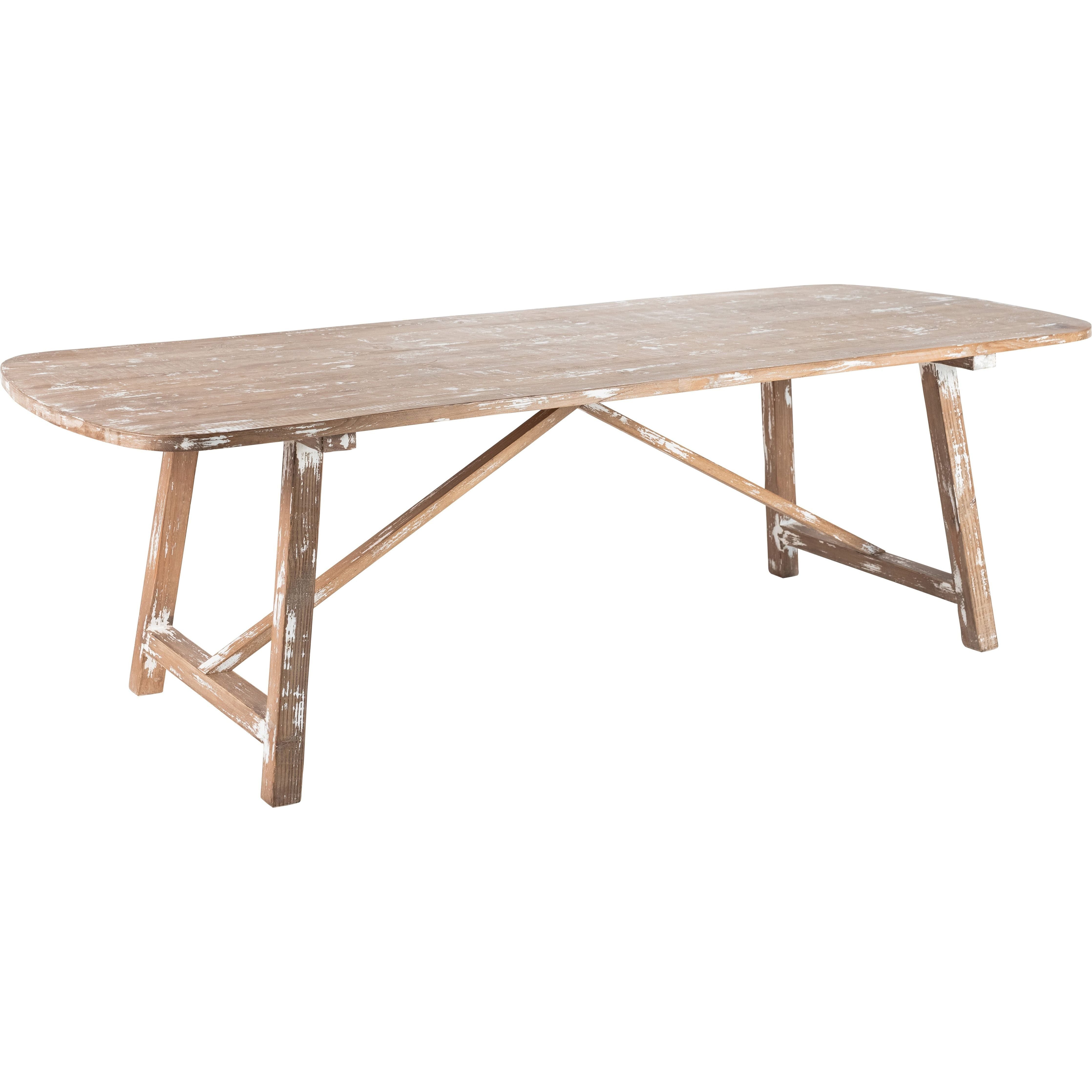 The Lexington Dining Table features a rustic design with a long, rectangular top made from distressed reclaimed pine with rounded edges. The weathered white finish adds sophistication, supported by sturdy angled trestle legs connected by a crossbar.