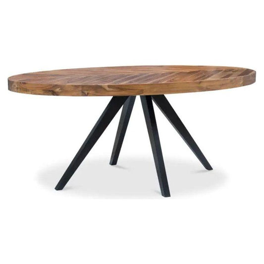 The Park Oval Dining Table features an oval wooden parquet-patterned top with a natural finish, showcasing a distinctive herringbone pattern. It is supported by four black, angled metal legs that converge at the center, creating a stable and modern base. The design seamlessly blends rustic and contemporary styles.