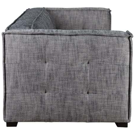 The Princeton Sofa in Charcoal features a side view of a modern gray fabric design with tufted details. Upholstered in a woven polyester blend, it has cushioned back and sides. The sofa exhibits clean lines and rests on short, dark wooden legs.