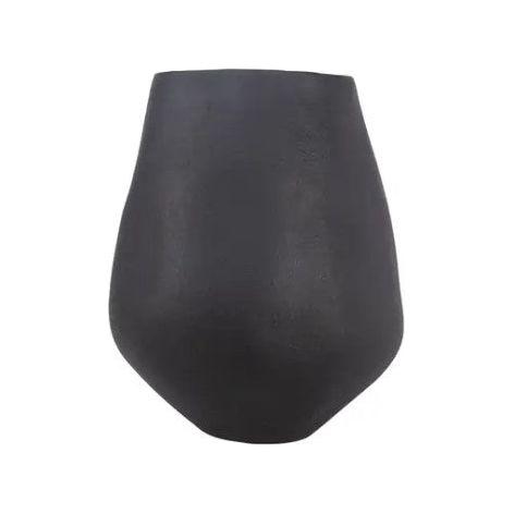This eco-friendly Rajasthan Decorative Vase features a matte black finish, an asymmetrical ceramic shape with a rounded base and tapered top. Hand-sculpted, it boasts subtle texture variations, bringing a minimalist and modern flair to contemporary decor. Perfect for unique styling needs.