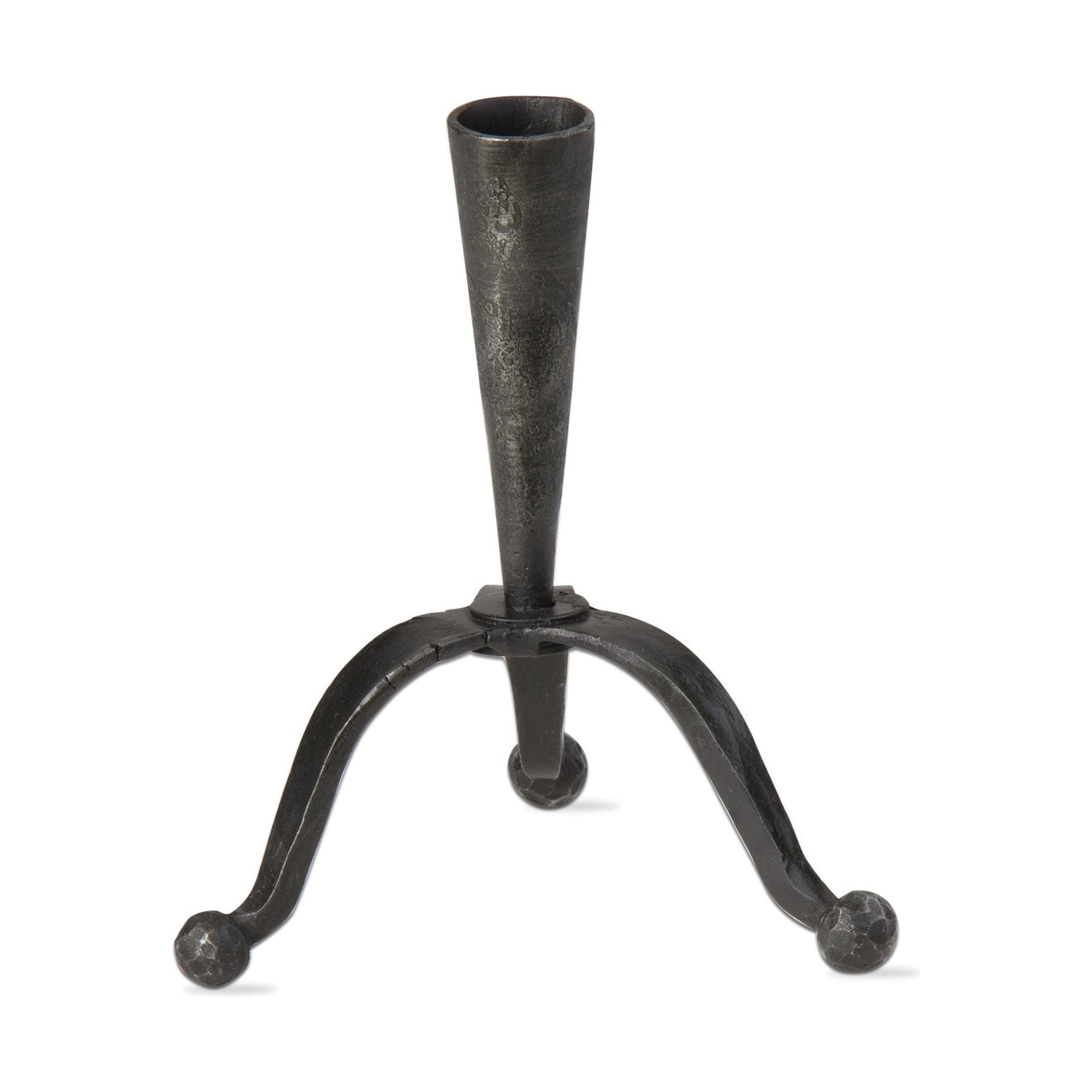 The Curved Base Iron Candleholder is a black wrought iron taper holder with a conical top and a curved base supported by three legs, each ending in round feet. Its simple and minimalist design exudes an antique and rustic charm against a plain white background.