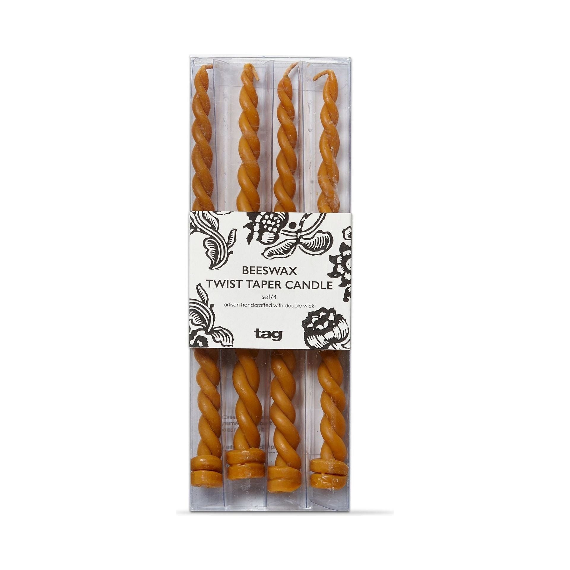 A set of four Honey Gold Beeswax Taper Candles with a spiral design, packaged in a clear plastic box. These eco-friendly, golden brown candles come with a label featuring floral illustrations that reads "Beeswax Twist Taper Candle Set/4" and proudly displays the "tag" brand name.