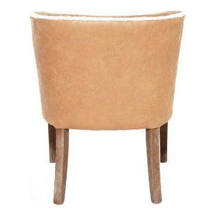 A shearling dining chair with a curved back and two visible wooden legs. The chair exhibits a simplistic yet elegant design, ideal for contemporary interiors.