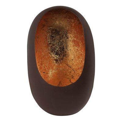 The Candlelight Pod is a smooth, oval-shaped sculpture with a dark brown exterior and a recessed, textured amber-colored center that features irregular patterns adorned with gold flecks. Its organic design creates a contrast between the solid, matte rust exterior and the vibrant reflections of candlelight off its gold leaf interior.